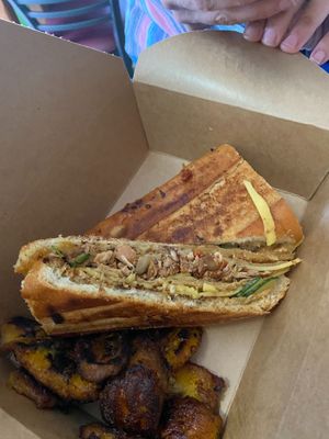 Vegan Cuban Sandwich it’s made with organic Cuban crispy bread, pressed on grill, oozing with vegan cheese yes some pickles, vegan sliced cheese, my very own spicy sauce. Served sweet crispy plantains  at Eden's Vegan Juice Bar Cafe in Palm Coast