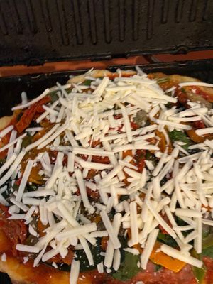 Oh wow vegan gluten-free pizzas sprinkled 100% vegan mozzarella cheese, hand made sauce spread over crust, layered kale, spinach or kale.  Slice and enjoy  at Eden's Vegan Juice Bar Cafe in Palm Coast