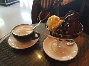 Chocolate cake and Coffee. The best desert here for sure, ice cream is just perfect with nice pieces and the cake is amazing. 10/10 at The Real Green Cafe in Pune