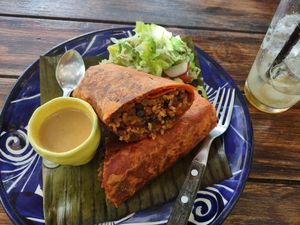 Updated menu for 2022, had a great burrito with side salad. at Suculenta in Tulum
