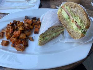 Veggie sandwich with Tofu Dill sauce, avocado, sprouts, tomato. Side of sweet potatoes   at Green Zebra Cafe in Sarasota