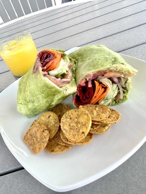 Veggie delight wrap with fresh veggies, avocado and hummus. The chips and juice are my own.   at Juicebox in Ocean View