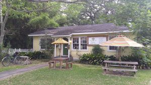 Store front with additional outdoor seating area is bike commute friendly. at Natural Living Food Co-op and Cafe in League City