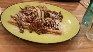 Strawberries and chocolate sauce on a crepe with vegan ice cream. at Rue de Creperie in Fitzroy