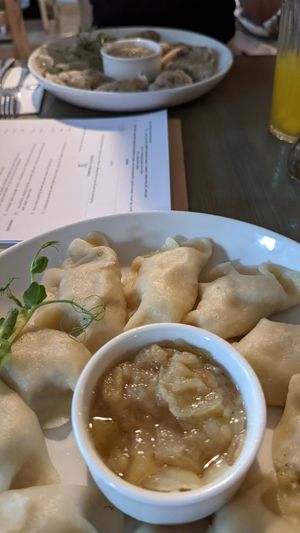 Vegan Piroggi filled with potato and Tofu. Onions as a Dip at Pierogarnia Mandu Oliwa in Gdansk