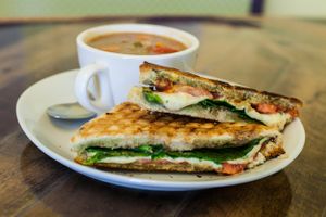 Caprese Panini-Focaccia, tomato, mozzarella, pesto with a balsamic drizzle and some greens at Cultivate Cafe in Destin