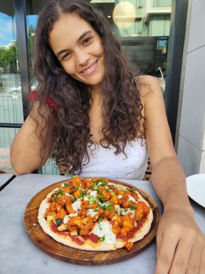 posing with my pizza at Cafe Gratitude in San Diego