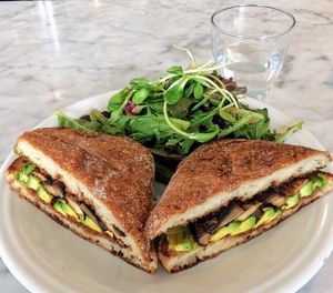 I am committed; swapped out everything with nuts (cole slaw and garnet yams) for side salad. Sandwich was good - disappointed so many things had nuts in them. The menu was a bit limited for me. at Cafe Gratitude in San Diego