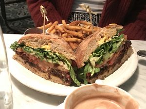 Vegan burger and fries with a almond milk cappuccino  at Cafe Gratitude in San Diego