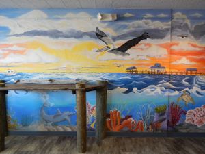 The Good Vibes MURAL(!) painted by Austin Jenquine, with our bar height dock.  Definitely a sight to see. at Good Vibes Juice in Largo