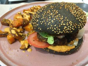 Burger with calçots and romesco and sweet potato fries at Väcka in Barcelona