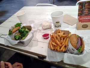 Shroom burger with zesty lemon broccoli, mustang relish burger with seaweed fries and a half eaten delicious cheesecake at VeganBurg in San Francisco