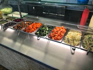 Toppings you can add to your falafel pita yourself, including tahina sauce, mango sauce, veggies, pickles, coriander sauce, spicy sauce, chickpea salad, onions, etc.  at Maoz - Albertcuypstraat in Amsterdam