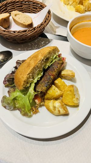 Gazpacho and vegan burger with veganesa and bravas  at The Mantraa in Barcelona