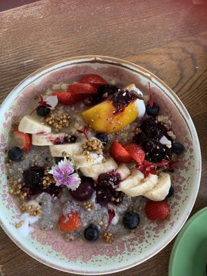 Soaked oats, quinoa and chia with poached pear and fresh fruit.   at Blendlove in Southport
