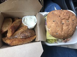 Sausage burger with cheese and coleslaw and skin on chips with aoli 😋 at The Wallflower Cafe in Herne Bay