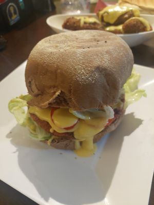Vegan burger with vegan Kibe &cheese at the back at Dona Augusta in Sao Paulo