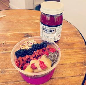 Delicious dragon fruit bowl with yummy toppings and some pomegranate hibiscus kombucha. at Real Raw Organics in Ocean City