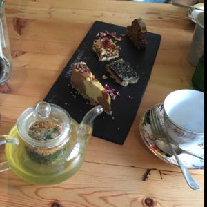 A selection of raw cakes and a pot of herbal tea.  at Asparagasm in Nailsworth