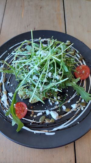Avocado on toast underneath the heap of greens at The Alkaline Cafe in Albany