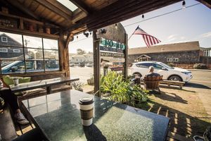 Comfortable front porch with heat lamps, great place to kick back with a cup of coffee. at Sleepy Monk Coffee Roasters in Cannon Beach