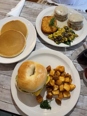 Breakfast bagel Sandwich with potatoes, biscuits and gravy with tofu scramble and hash browns and a side of pancakes. Amazing!   at New Leaf Cafe in Tampa