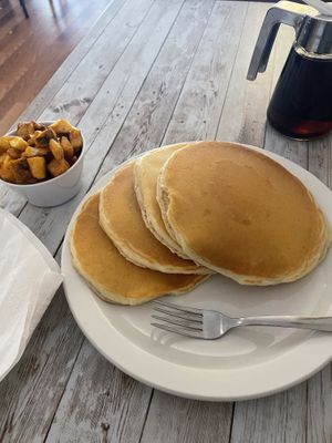 pancakes with a side of breakfast potatoes  at New Leaf Cafe in Tampa