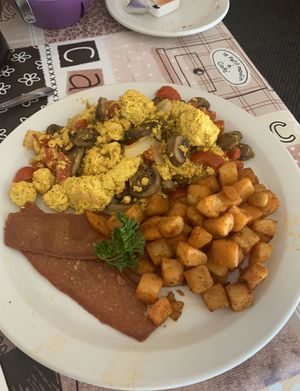 Tofu scramble with vegetables, home fries, and life light bacon at New Leaf Cafe in Tampa