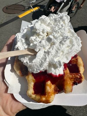 Liege waffle with red fruit sauce and whipped cream at WafflesVeg in Paris