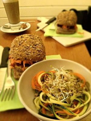 Vegan burger-sandwich with melted cheese and salad on side.  at Kafe PUUR in Antwerpen