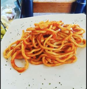 Pici all’aglione - Homemade pasta with garlic and tomato sauce at La Mensa del Conte in Pienza