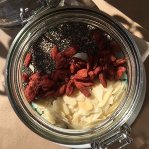 Topping of the spirulina smoothie bowl: chia seeds, goji berries, and almonds. at H2O Juice Bar & Vegan Cafe in Fuerteventura