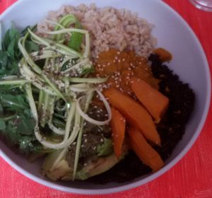 Curry Bowl (special edition) with brown rice, sweet potatoes, zucchini spaghetti, arugula, avocado, pesto, fresh dressing, and black quinoa at Delicious Vegan Bistro in Vienna