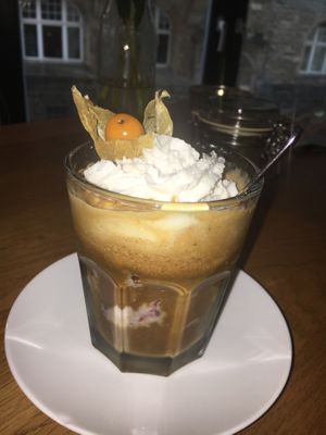 a scoop of vanilla chocolate cherry ice cream with an espresso shot, oat milk and vegan cream  at TONIS in Leipzig