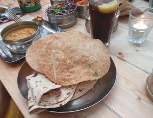 Roti bread and puri (purple dish in the back ground is 'Mowgli Slaw') at Mowgli in Manchester