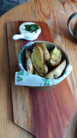 rustic potato wedges with a side of pesto sauce at La Verde in Lima
