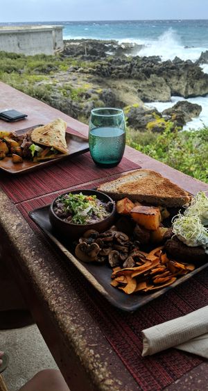 Breakfast platter and ChickVeg Piadina with the view at Vivo Cafe & Restaurant in West Bay