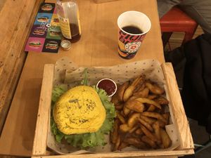 Spicy burger (yellow bun) with plenty of fries  at Flower Burger - Viale Vittorio Veneto in Milan