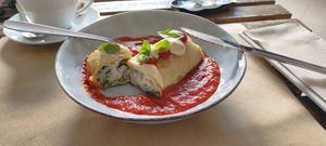 Crespella: Baked crepe filled with spinach and almond ricotta cheese; served with tomato sauce, and cashew cheese drops at BuenaVida Vegan in Tenerife