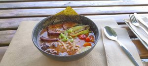 Ramen: Spicy ramen boullion with noodles, seitan, carrot, mushrooms, soy beans and vegetables of the day. at BuenaVida Vegan in Tenerife
