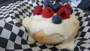 Cream cheese frosting with fresh berries at Cinnaholic in Southlake
