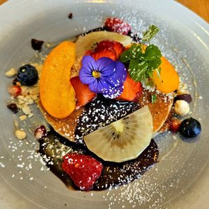 Amazing pancakes with fruit, nuts, and chocolate sauce at Le Potager de Charlotte in Paris