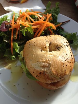 Sunday brunch special - fresh, locally-baked bagel with red pepper hummus, avocado, sun-dried tomato; and delicious dressing on the side salad! at Espresso Library in Cambridge