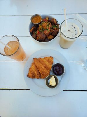 Croissant and Crispy Potatoes with Iced Coffee and Watermelon Lychee Juice at Little Pine in Los Angeles