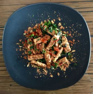 Marinated tempeh stir fried in organic coconut oil. at Alice's Restaurant  in Chiang Mai