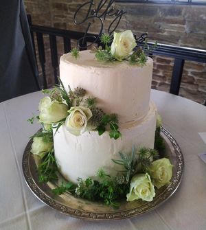 Vegan and gluten-free wedding cake with fresh flowers at The Kind Cake Co in Hebden Bridge
