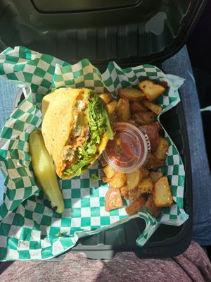 Veggie chicken tender wrap and fried potatoes. I ate the other half 😂 but it comes with both. at Dancing Avocado in Daytona Beach