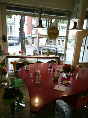 The lovely central big table with dog pillow below at Fancy Foods in Wuppertal
