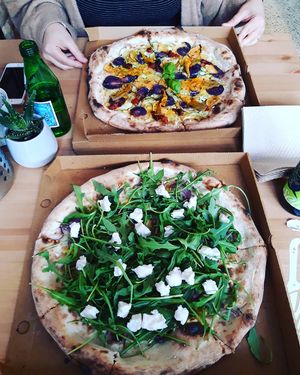 Pizzas we shared, one with vegan brie (Sweet Earth) and  the other with sweet potatoes and zucchini blossoms (Flower Blossom). at Pizzeria Dope in Amsterdam