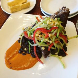 I forget but some savory teff cake = amazing. at Luna Rotisserie & Empanadas in Durham